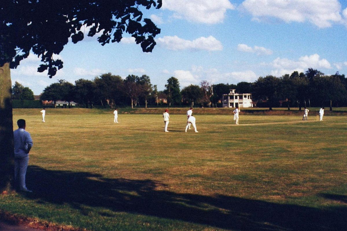 A cricket match being played on a sunny day in Norwich, showcasing players in action.
